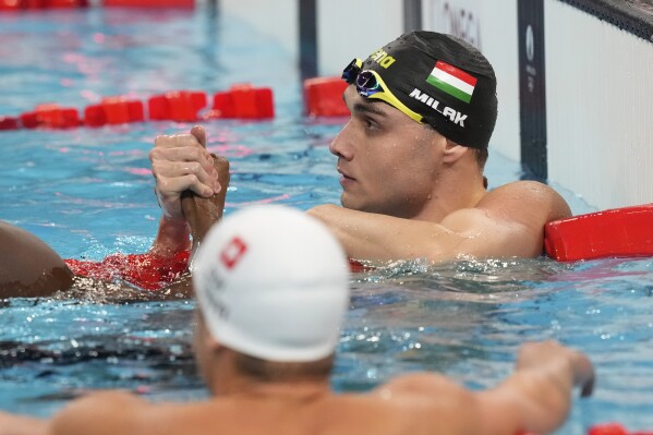 Hungary's Kristof Milak celebrates winning the gold medal in the men's 100-meter butterfly final at the Summer Olympics in Nanterre, France, Saturday, Aug. 3, 2024. (AP Photo/Tsvangirayi Mukwazhi)