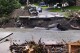 A loader dumps dirt along a washed out portion of Mill Street after remnants of Hurricane Beryl caused flooding and destruction, Friday, July 12, 2024, in Plainfield, Vt. (AP Photo/Charles Krupa)