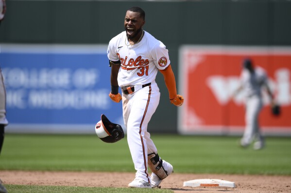 Baltimore Orioles' Cedric Mullins celebrates after he hit a two RBI walk-off double to win a baseball game against the New York Yankees, Sunday, July 14, 2024, in Baltimore. (AP Photo/Nick Wass)