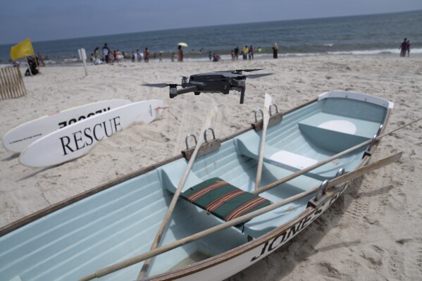 A drone is flown in for a landing after a shark patrol flight at Jones Beach State Park in Wantagh, N.Y. (AP Photo/John Minchillo)