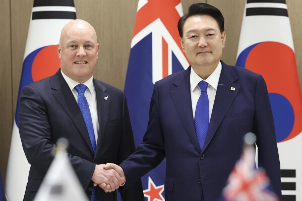 South Korean President Yoon Suk Yeol, right, shakes hands with New Zealand's Prime Minister Christopher Luxon during a meeting at the Presidential Office in Seoul, South Korea, Wednesday, Sept. 4, 2024. (Jin Sung-chul/Yonhap via AP)