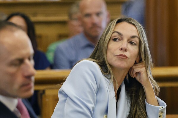 Karen Read listens to her attorney, Martin Weinberg, who was making motions to dismiss two charges against her, at Norfolk Superior Court in Dedham, Mass., Friday, Aug. 9, 2024. (Greg Derr/The Patriot Ledger via AP, Pool)