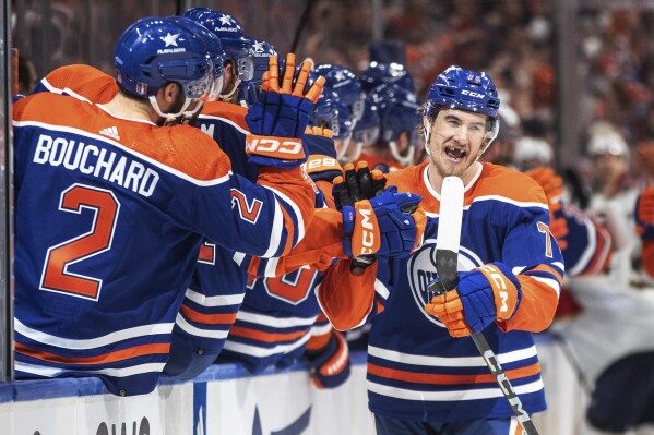 Edmonton Oilers' Ryan McLeod (71) is congratulated for a goal against the Florida Panthers during the third period of Game 6 of the NHL hockey Stanley Cup Final, Friday, June 21, 2024, in Edmonton, Alberta. The Oilers won 5-1 to tie the series. (Jason Franson/The Canadian Press via AP)