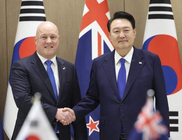 South Korean President Yoon Suk Yeol, right, shakes hands with New Zealand's Prime Minister Christopher Luxon during a meeting at the Presidential Office in Seoul, South Korea, Wednesday, Sept. 4, 2024. (Jin Sung-chul/Yonhap via AP)