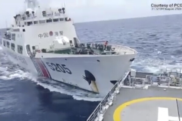 In this image taken from handout video provided by the Philippine Coast Guard, a Chinese Coast Guard ship with bow number 5205, right, collides with Philippine Coast Guard vessel BRP Teresa Magbanua near the Sabina Shoal at the disputed South China Sea on Saturday Aug. 31, 2024. (Philippine Coast Guard via AP)