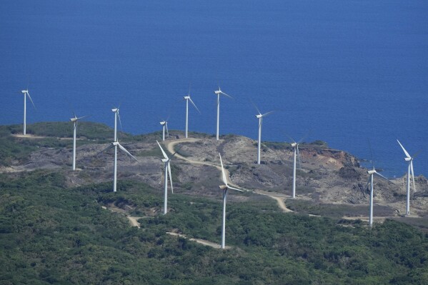 FILE - Windmills are seen at Ilocos Norte province, northern Philippines on Monday, May 6, 2024. (AP Photo/Aaron Favila)