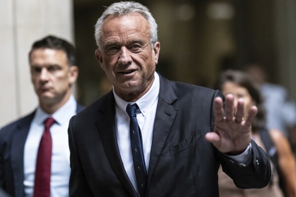 Independent presidential candidate Robert F. Kennedy Jr., waves to the media outside the Nassau County Supreme Court in Mineola, N.Y. on Wednesday, Aug., 21, 2024. (AP Photo/Stefan Jeremiah)