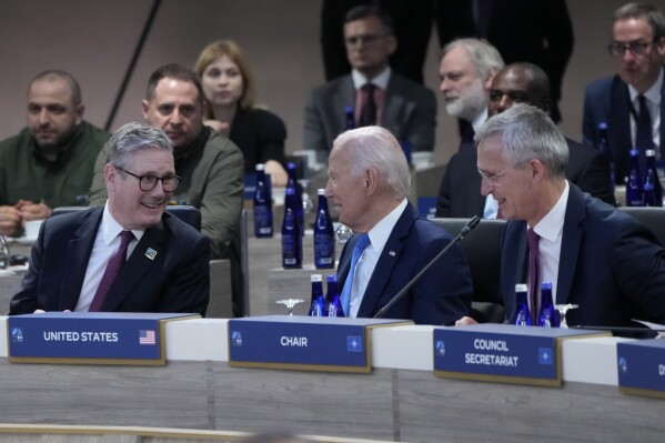 British Prime Minister Keir Starmer talks with President Joe Biden and NATO Secretary General Jens Stoltenberg before a meeting of the NATO-Ukraine Council during the NATO summit in Washington, Thursday July 11, 2024. (AP Photo/Jacquelyn Martin)