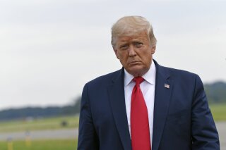 President Donald Trump walks over to speak with the press after arriving on Air Force One at Morristown Municipal Airport in Morristown, N.J., Friday, Aug. 14, 2020. Trump heading to New York to visit with his younger brother, Robert Trump, who has been hospitalized in New York. (AP Photo/Susan Walsh)