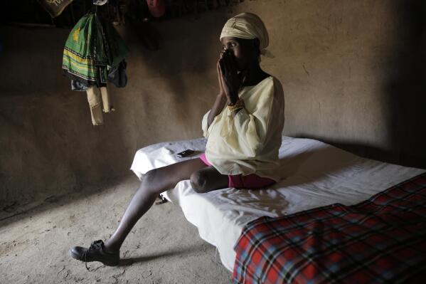 Winnie Keben gets emotional at Meisori village in Baringo County, Kenya, on Thursday, July 21, 2022, as she narrates how she was attacked in Lake Baringo. Keben lost her leg to a crocodile attack, and that accident plus the loss of her home to rising water drove her and her family from their village. (AP Photo/Brian Inganga)