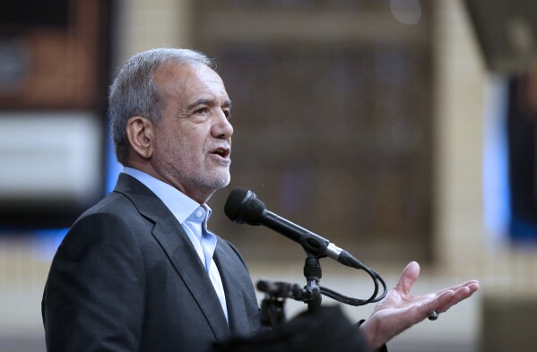 In this photo released by the official website of the office of the Iranian supreme leader, newly elected President Masoud Pezeshkian speaks after receiving official seal of approval of Supreme Leader Ayatollah Ali Khamenei in an endorsement ceremony in Tehran, Iran, Sunday, July 28, 2024. (Office of the Iranian Supreme Leader via AP)