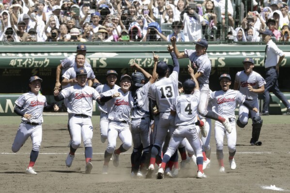 Kyoto International High School's team members celebrate as they won Japan's famous summer high school baseball tournament at a stadium in Nishinomiya, western Japan Friday, Aug. 23, 2024. (Kyodo News via AP)