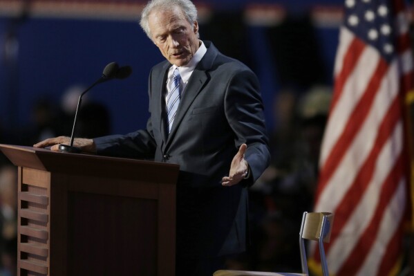FILE - Actor Clint Eastwood speaks to an empty chair while addressing delegates during the Republican National Convention in Tampa, Fla., Aug. 30, 2012. Presidential conventions can be memorable for floor fights and bloody battles on the streets outside, or for scenes that standout as outlandish or awkward. From Eastwood haranguing of an empty chair in 2012 to Al and Tipper Gore's uncomfortably long kiss in 2000 and pitched battles between police and protesters outside in Chicago in 1968, conventions past have produced many memorable moments. (AP Photo/Lynne Sladky, File)