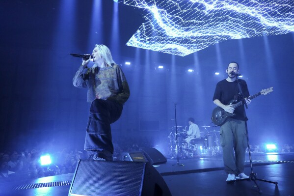 Emily Armstrong, from left, Colin Brittain, and Mike Shinoda of Linkin Park perform Thursday, Sept. 5, 2024, in Los Angeles. It was announced on Thursday that Dead Sara's Emily Armstrong would join as the band's new co-singer and songwriter/producer Colin Brittain would join on drums. Linkin Park will release the album "From Zero" on Nov. 15, marking their first new record since former frontman Chester Bennington died in 2017. (Photo by Jordan Strauss/Invision/AP