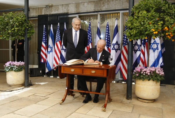 FILE - Israel's Prime Minister Benjamin Netanyahu looks at U.S Vice President Joe Biden as he signs the guest book at the Prime Minister's residence in Jerusalem, March 9, 2010. U.S. Vice President Joseph Biden says there is a "moment of opportunity" for peace between Israelis and Palestinians. Historians and political advisers say history will be kinder to President Joe Biden than voters have been. Biden dropped out of the presidential race Sunday, July 21, 2024, clearing the way for a new Democratic nominee. (AP Photo/Ariel Schalit, File)