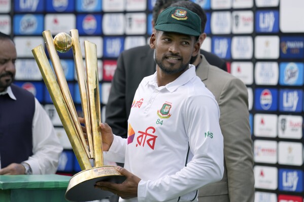 Bangladesh's Najmul Hossain Shanto holds trophy after winning the test cricket series against Pakistan at a ceremony, in Rawalpindi, Pakistan, Tuesday, Sept. 3, 2024. (AP Photo/Anjum Naveed)