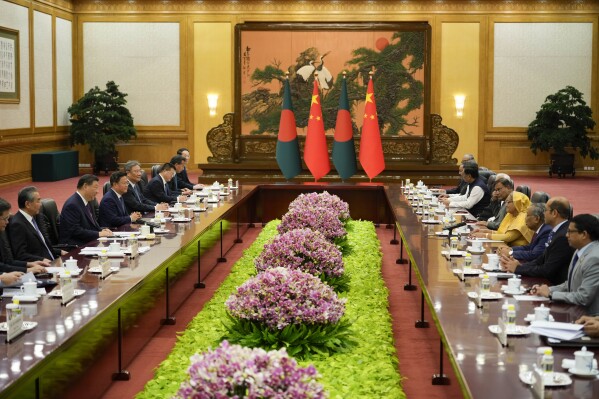 Chinese President Xi Jinping, second from left, and his delegation attend a meeting with Bangladesh Prime Minister Sheikh Hasina, fourth from right, at the Great Hall of the People in Beijing, China, Wednesday, July 10, 2024. (AP Photo/Vincent Thian, Pool)