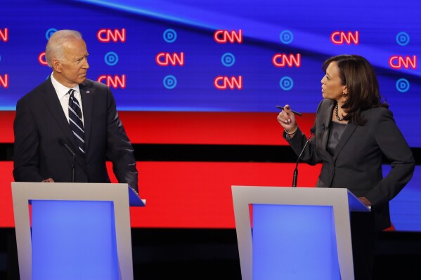 FILE - Former Vice President Joe Biden, left, listens as Sen. Kamala Harris, D-Calif., speaks during a Democratic presidential primary debates, July 31, 2019, in Detroit. (AP Photo/Paul Sancya, File)