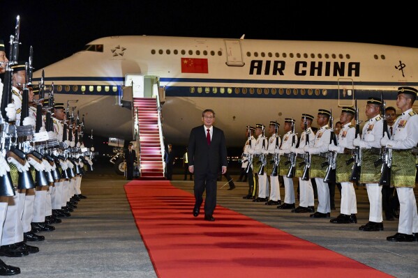 In this photo released by Malaysia's Department of Information, China's Premier Li Qiang arrives at Sepang International Airport in Kuala Lumpur, Malaysia, Tuesday, June 18, 2024. (Malaysia's Department of Information via AP)