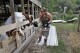 Catherine Ward, owner of One Acre Farms, a functioning educational farm to help special needs kids, walks over blown off roof tin segments as she feeds some of her anxious goats Friday, July 12, 2024, in Porter, Texas. In addition to the damage, Ward has been without power since hurricane Beryl passed through and is running the farm on a large portable generator, mainly used to keep the water well functioning for all the livestock. (AP Photo/Michael Wyke)