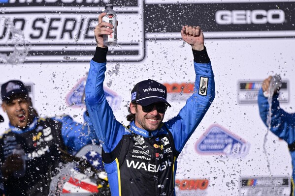 Ryan Blaney celebrates in the victory lane after winning a NASCAR Cup Series auto race at Pocono Raceway, Sunday, July 14, 2024, in Long Pond, Pa. (AP Photo/Derik Hamilton)