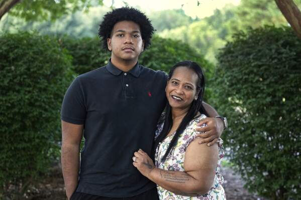 Robin Alderman, right, and her son, Camden Alderman, 21, pose for a portrait near their home in Greensboro, N.C., Wednesday, June 12, 2024. Camden, 21, was diagnosed as a baby with a rare disease called Wiskott-Aldrich syndrome, which is caused by a mutated gene on the X chromosome. It primarily affects boys – up to 10 out of every million — and can cause frequent infections, eczema and excessive bleeding. (AP Photo/Chuck Burton)