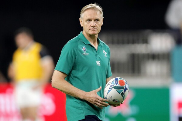 FILE - Ireland's coach Joe Schmidt watches as his players warm up ahead of the Rugby World Cup Pool A game at Kobe Misaki Stadium between Ireland and Russia, in Kobe, Japan, on Oct. 3, 2019. Liam Wright will lead the Wallabies against Wales after Joe Schmidt completely overhauled Australia’s squad on Thursday, July 4, 2024 for his first test in charge. (AP Photo/Christophe Ena, File)
