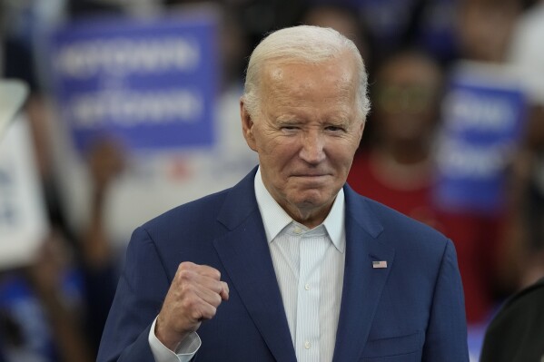 President Joe Biden is gesturing before speaking at a campaign event at Renaissance High School, Friday, July 12, 2024, in Detroit. (AP Photo/Carlos Osorio)