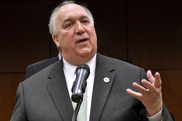 FILE - Former Michigan Gov. John Engler speaks at a news conference on Jan. 31, 2018, in East Lansing, Mich. (Dale G.Young/Detroit News via AP, File)