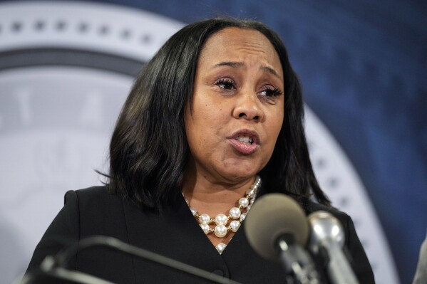 FILE - Fulton County District Attorney Fani Willis speaks during a news conference, Aug. 14, 2023, in Atlanta. People connected with former President Donald Trump’s legal cases have been inundated with threats. In Atlanta, Willis, who brought criminal charges against Trump and 18 other people alleging they schemed to illegally overturn the 2020 election results in Georgia, is known to be accompanied by round-the-clock bodyguards. (AP Photo/John Bazemore, File)