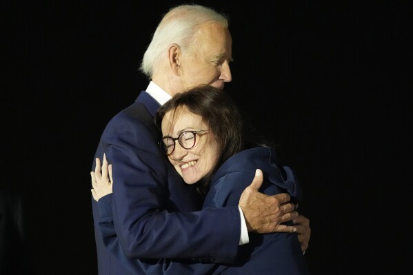 President Joe Biden, left, hugs Alsu Kurmasheva at Andrews Air Force Base, Md., following her release as part of a 24-person prisoner swap between Russia and the United States, Thursday, Aug. 1, 2024. (AP Photo/Alex Brandon)