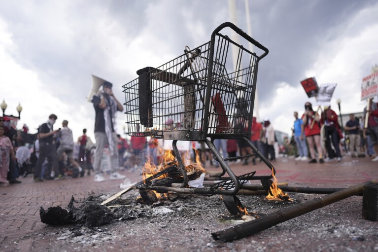 The aftermath of the burning of an effigy of Israeli Prime Minister Benjamin Netanyahu and also an Israeli flag as protestors look on, Wednesday, July 24, 2024, in Washington near Union Station and the U.S. Capitol. (AP Photo/Mike Stewart)