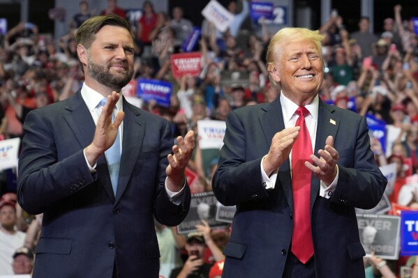 Republican presidential candidate former President Donald Trump and Republican vice presidential candidate Sen. JD Vance, R-Ohio, arrive a campaign rally, Saturday, July 20, 2024, in Grand Rapids, Mich. (AP Photo/Evan Vucci)