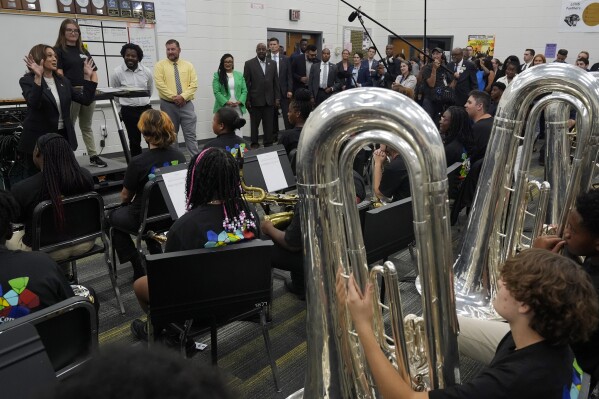 Democratic presidential nominee Vice President Kamala Harris speaks to marching band members at Liberty County High School in Hinesville, Ga., Wednesday, Aug. 28, 2024. (AP Photo/Jacquelyn Martin)