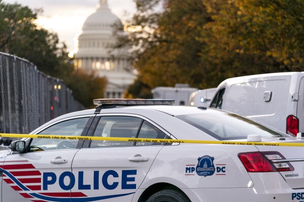 FILE - A Washington Metropolitan Police vehicle is seen near the Capitol, Oct. 19, 2022, in Washington. Three gun shops that sold nearly three dozen firearms to a man who trafficked the weapons in and around Washington, D.C., are facing a new lawsuit filed Tuesday, jointly by attorneys general for Maryland and the nation’s capital. (AP Photo/J. Scott Applewhite, File)