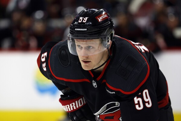 FILE - Carolina Hurricanes' Jake Guentzel (59) watches the puck during the second period of an NHL hockey game against the Boston Bruins in Raleigh, N.C., April 4, 2024. The Tampa Bay Lightning got a head start on free agency by acquiring the rights to high-scoring winger Guentzel. The Lightning sent a 2025 third-round draft pick to Carolina on Sunday, June 30. (AP Photo/Karl B DeBlaker, File)