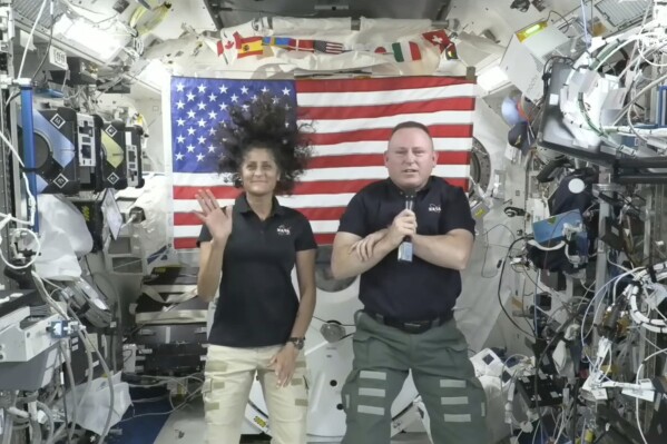 In this image from video provided by NASA, astronauts Suni Williams, left, and Butch Wilmore give a news conference aboard the International Space Station on Wednesday, July 10, 2024. (NASA via AP)