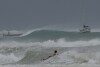 A surfer braves the waves in Carlisle Bay as Hurricane Beryl passes through Bridgetown, Barbados, July 1, 2024. (AP Photo/Ricardo Mazalan)