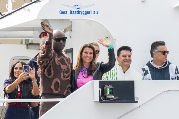 Norway's Princess Martha Louise and Durek Verret arrive at the boats in Alesund, Norway, Friday Aug. 30, 2024. that will transport them to Geiranger for their wedding celebration on Saturday. (Heiko Junge/NTB via AP)