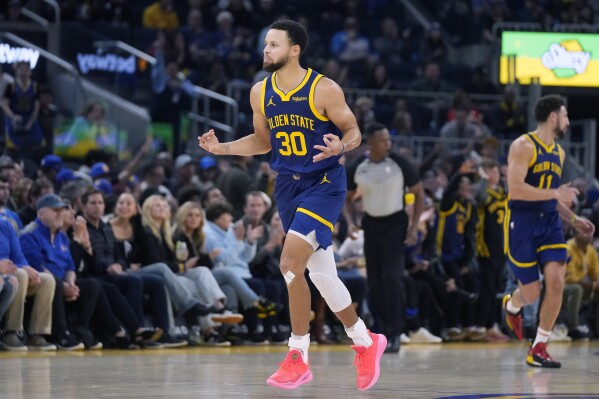 FILE - Golden State Warriors guard Stephen Curry (30) gestures after making a 3-point basket during the first half of an NBA basketball game against the Oklahoma City Thunder in San Francisco, Saturday, Nov. 18, 2023. All-Star Saturday Night, Feb. 17, 2024, gets an event like never before: Sabrina Ionescu vs. Stephen Curry, in a 3-point battle of the sexes. (AP Photo/Jeff Chiu, File)