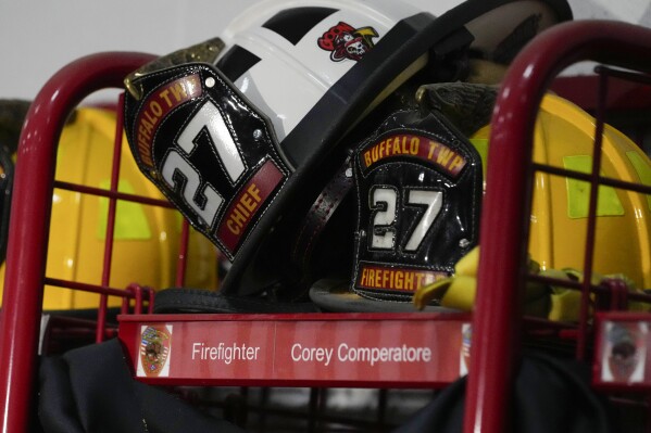 Helmets rest on the locker of firefighter Corey Comperatore at the Buffalo Township Fire Company 27 in Buffalo Township, Pa., Sunday, July 14, 2024. Comperatore was killed during a shooting at a campaign rally for Republican presidential candidate former President Donald Trump in Butler, Pa., on Saturday. (AP Photo/Sue Ogrocki)