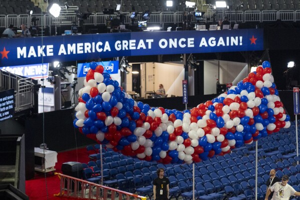 FILE - Balloons are hoisted to the ceiling in the Forum ahead of the 2024 Republican National Convention, July 12, 2024, in Milwaukee. Nearly 2,500 delegates gather this week for a roll call vote to select a the Republican presidential nominee, formally ending the presidential primary. Former President Donald Trump has already been the presumptive nominee for months, having clinched a majority of convention delegates on March 12, but he doesn't officially become the party's standard-bearer until after the roll call. (AP Photo/Alex Brandon)