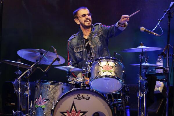 FILE - Ringo Starr plays as part of a concert celebrating the 50th anniversary of Woodstock in Bethel, N.Y., Friday, Aug. 16, 2019. Starr has tested positive for COVID-19, forcing the former Beatle to cancel several upcoming concerts in Canada with his All Starr Band. (AP Photo/Seth Wenig, File)