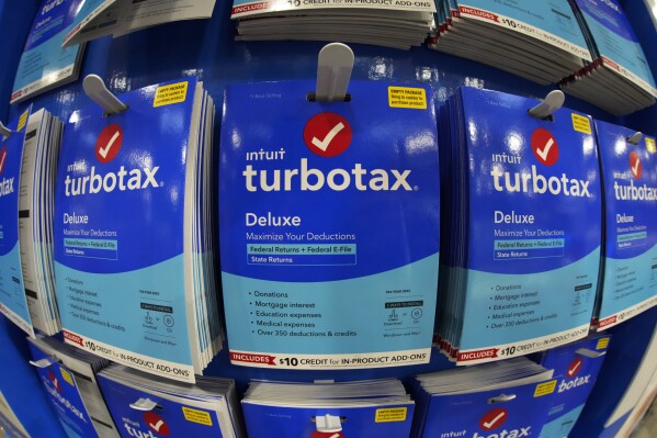 FILE - Intuit TurboTax packages are seen on display in a Costco Warehouse, Jan. 26, 2023, in Pittsburgh. Tax preparation and financial software company Intuit announced an AI-focused reorganization plan Wednesday, July 10, 2024, that includes laying off about 10% of its workforce. (AP Photo/Gene J. Puskar, File)