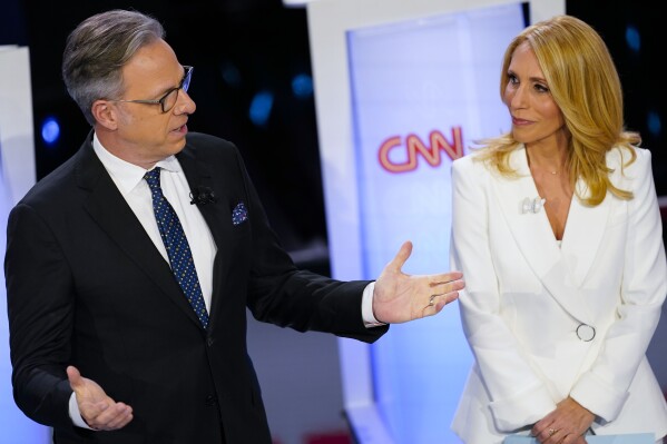 FILE - CNN anchors Jake Tapper, left, and Dana Bash, right, speaking to members of the audience before the start of the CNN Republican presidential debate in Des Moines, Iowa, Wednesday, Jan. 10, 2024. The two planned presidential debates between Joe Biden and Donald Trump that were swiftly organized this week, Thursday, May 16, 2024, are good news for CNN and ABC News. (AP Photo/Andrew Harnik, File)