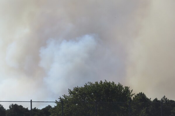 Large plumes of smoke rise from a forest fire in Berkeley Township, N.J. on Tuesday, Sept. 10, 2024. (AP Photo/Wayne Parry)