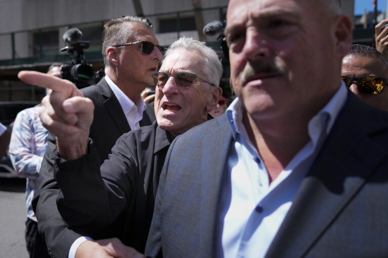 Robert De Niro, center, argues with a Donald Trump supporter after speaking to reporters in support of President Joe Biden across the street from Trump's criminal trial in New York, on May 28, 2024. (AP Photo/Seth Wenig)