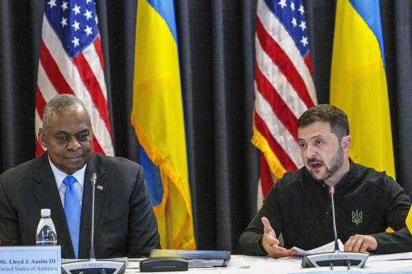 U.S. Defense Secretary Lloyd Austin, left, listens to Ukraine's President Volodymyr Zelenskyy during a meeting also with German's Defense Minister Boris Pistorius and Chairman of the Joint Chiefs of Staff Air Force of the U.S. Gen. CQ Brown at Ramstein Air Base in Ramstein-Miesenbach, Germany, Friday, Sept. 6, 2024. (Andreas Arnold/dpa via AP)