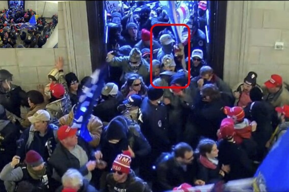 This image from U.S. Capitol Police security video and contained in the government's sentencing memorandum for Tyler Bradley Dykes, marked in red by source, shows him in the U.S. Capitol on Jan. 6, 2021, in Washington. Dykes, a South Carolina resident and active Marine accused of flashing a Nazi salute during the insurrection, has been sentenced to nearly five years in prison for assaulting police officers who were guarding the building. Dykes grabbed a police riot shield from the hands of two police officers and used it to push his way through police lines at the Capitol.(Department of Justice via AP)
