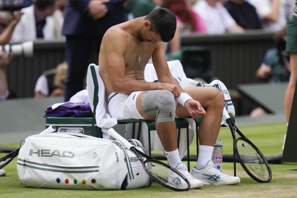 Novak Djokovic of Serbia reacts during a break in his match against Carlos Alcaraz of Spain during the men's singles final at the Wimbledon tennis championships in London, Sunday, July 14, 2024. (AP Photo/Alberto Pezzali)